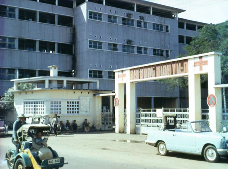 an image of an old building with cars parked near it