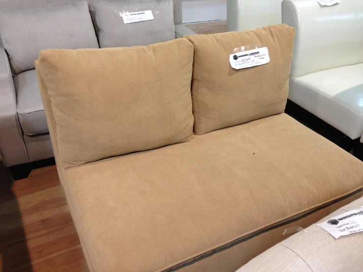 a couch with a tag sitting next to it