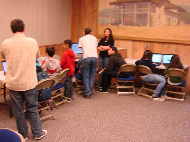 people in a room with a lot of chairs