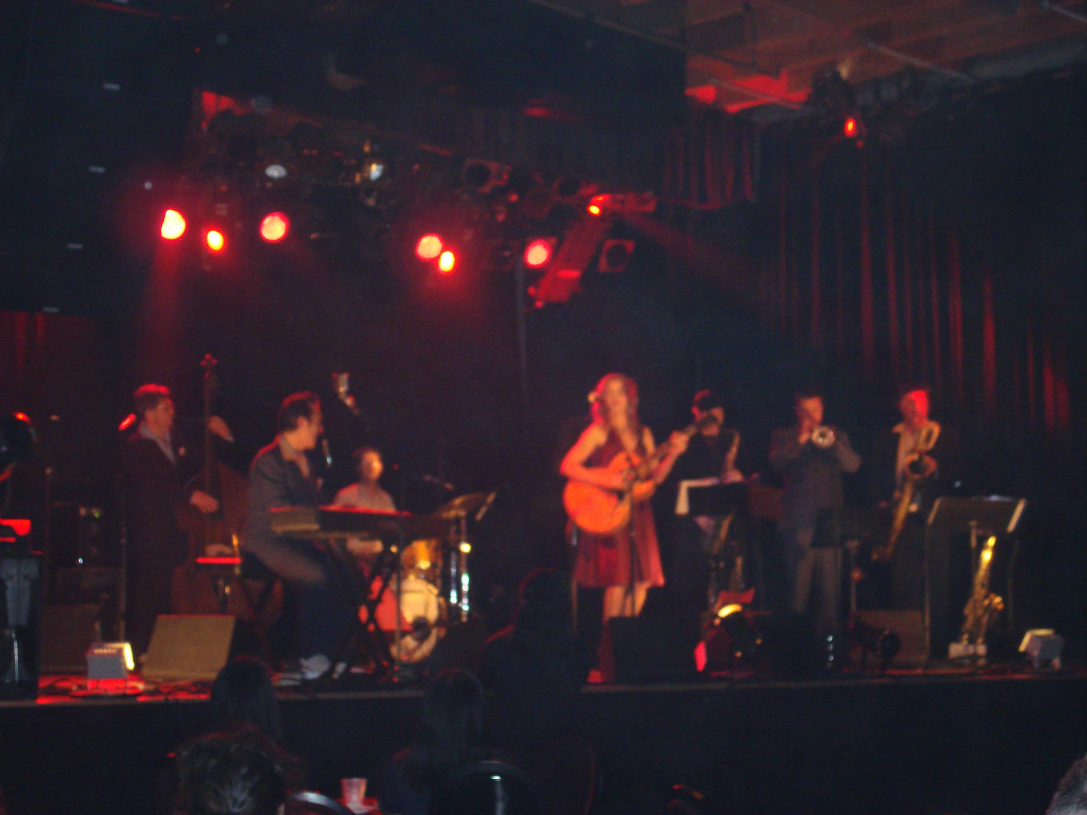 a band plays on stage at night with spotlights