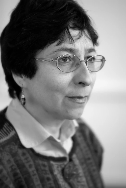 woman in glasses in black and white image with collar