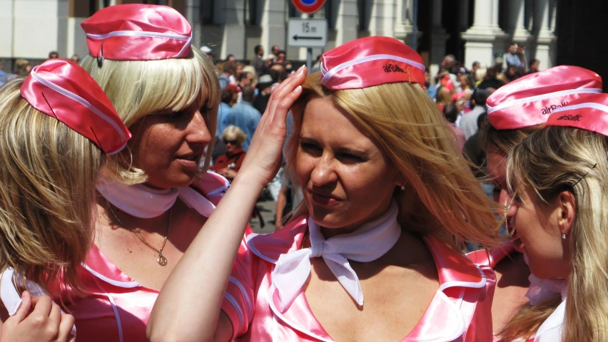 a group of women dressed in pink standing next to each other