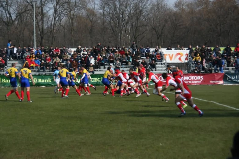 group of football players running on the field