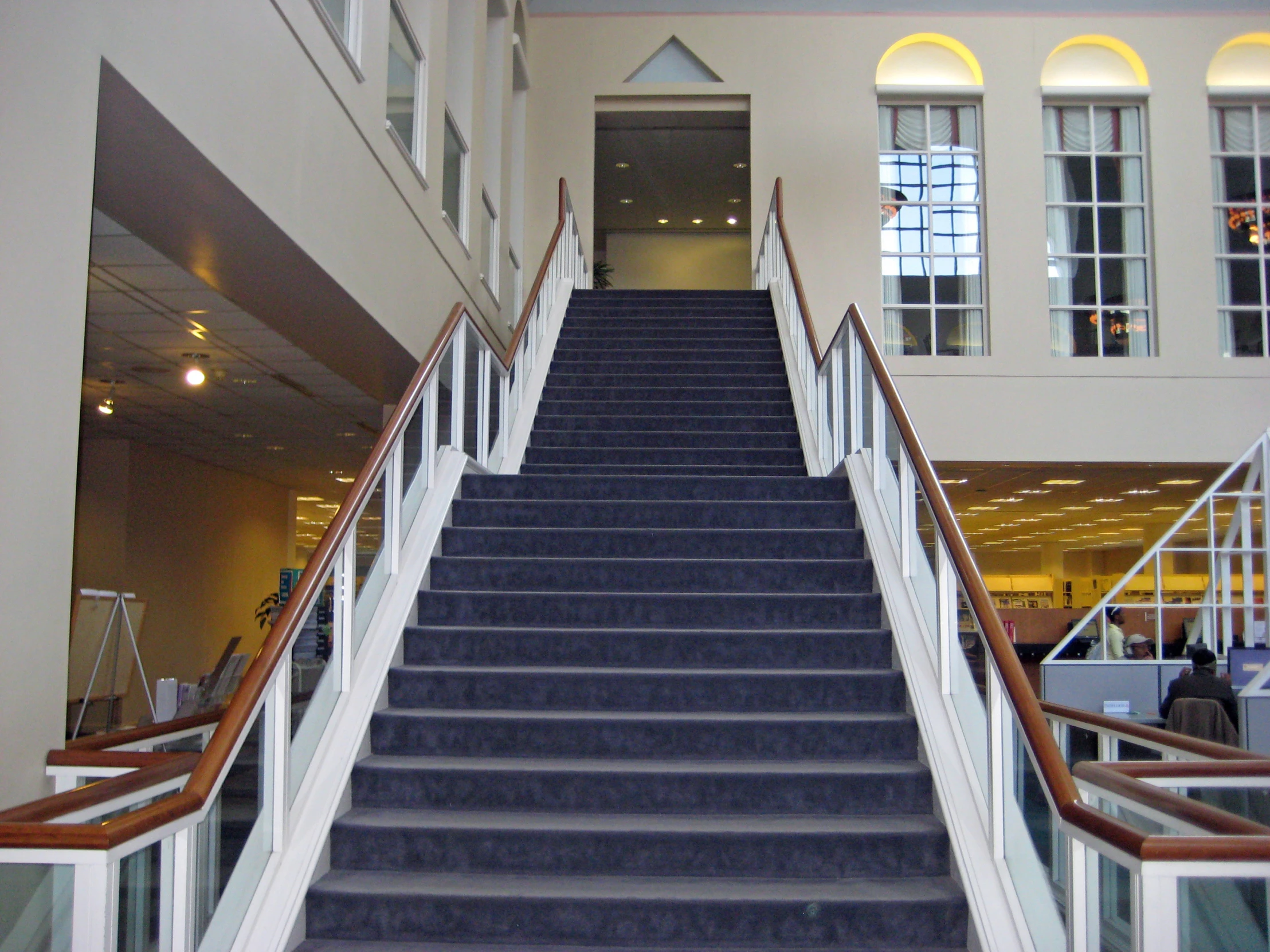 two sets of blue stairs lead to an exit