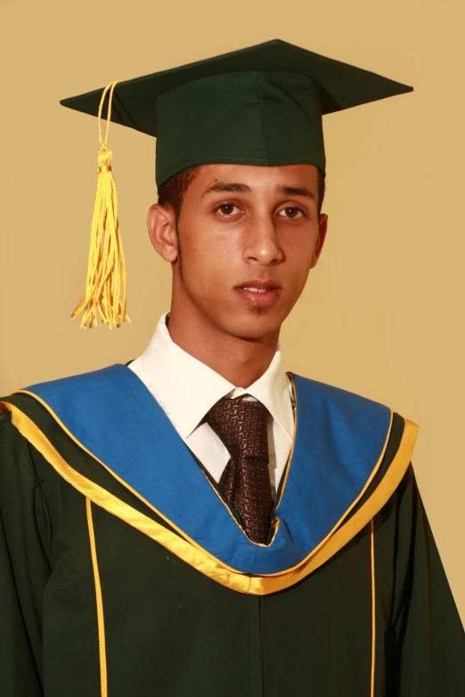 a young male in a graduation gown and cap