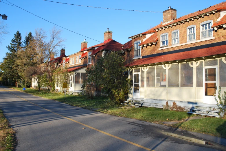 an empty road in front of rows of small houses