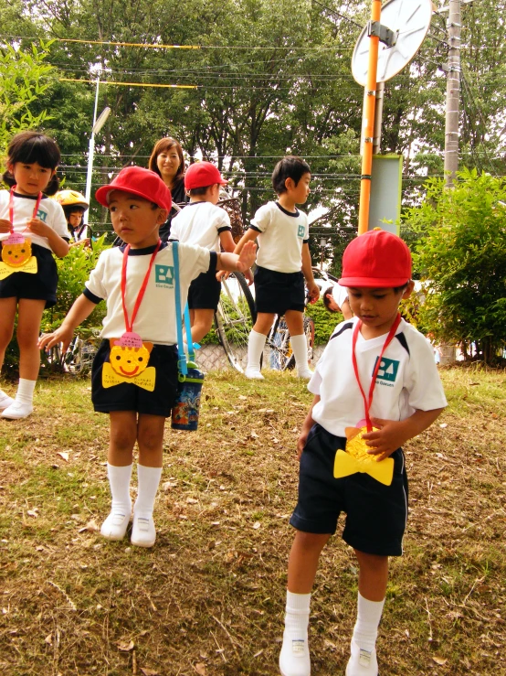 the young s are wearing red caps while playing a game