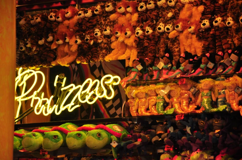 many stuffed bears sitting in a shop with neon lights