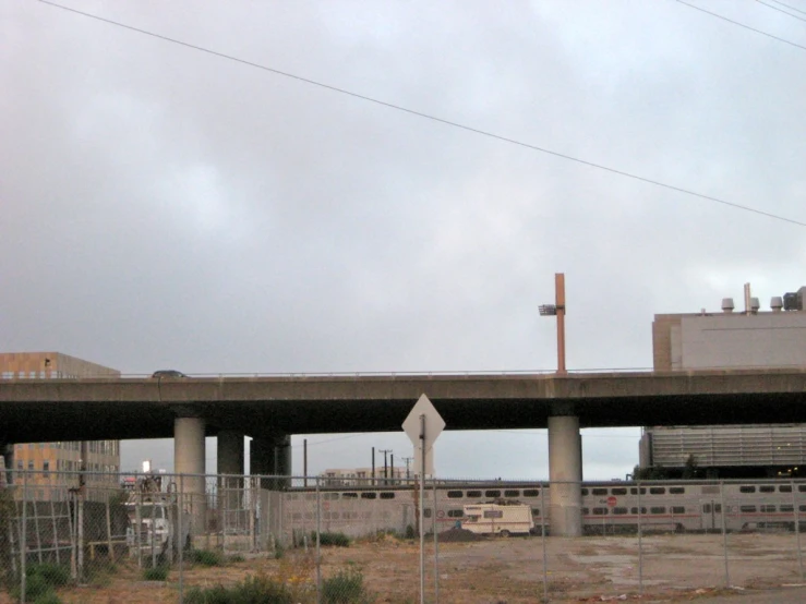 a street bridge going over a dirt road