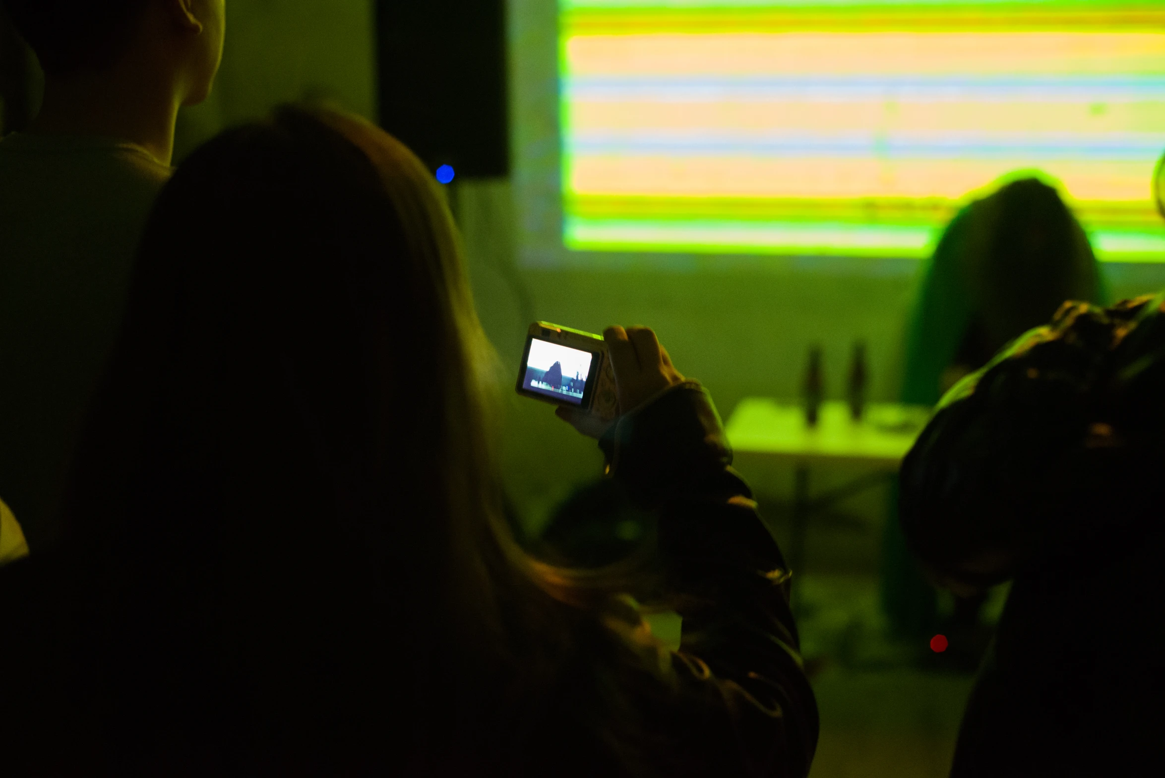 a man is recording music using his cell phone