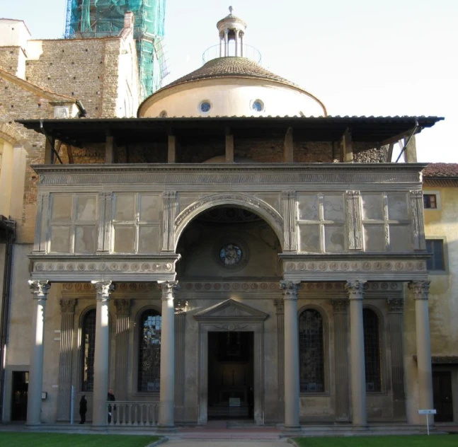 a large building with columns and some arches