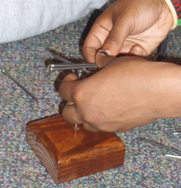 a person holding soing in his hands on top of wood