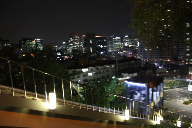 a view of a city at night with buildings and cars