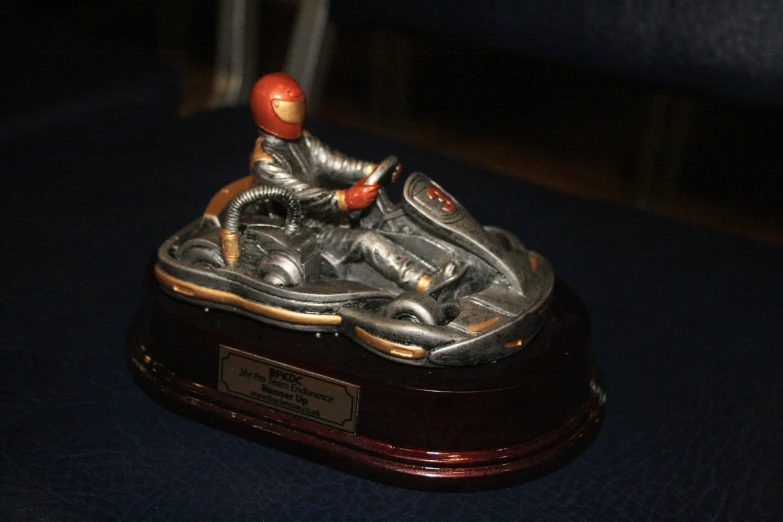 a miniature motorcycle sitting on top of a blue table