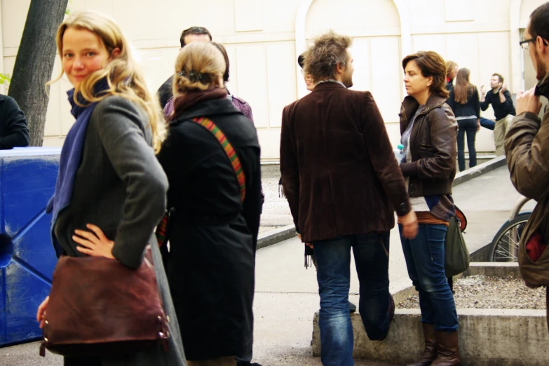 a group of people standing in the middle of a street