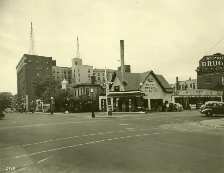 an old time black and white po of a pub, cars, and a street