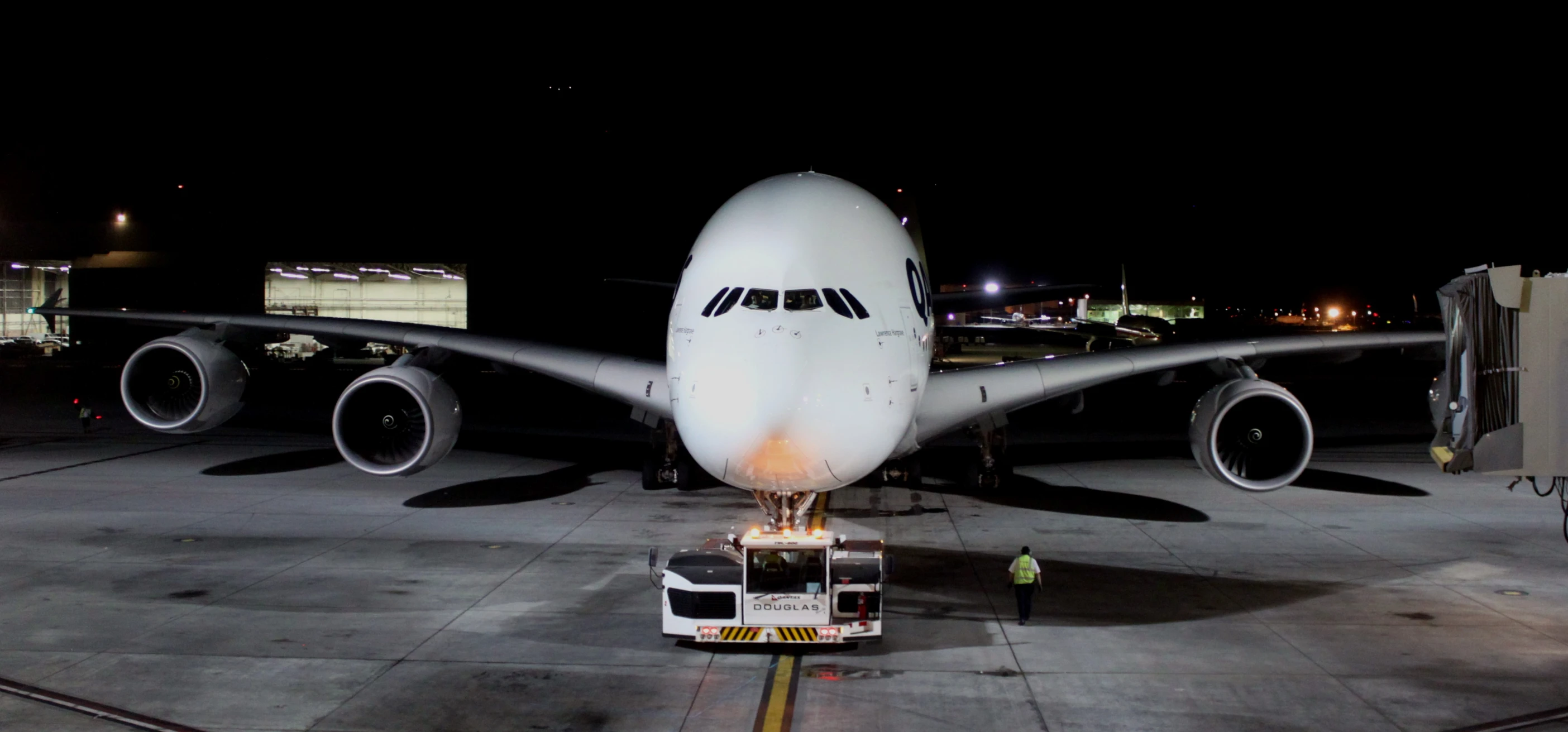an airplane is sitting on the runway at night