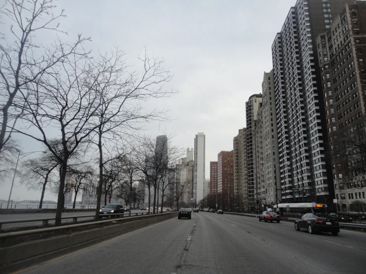 an empty street with traffic and tall buildings