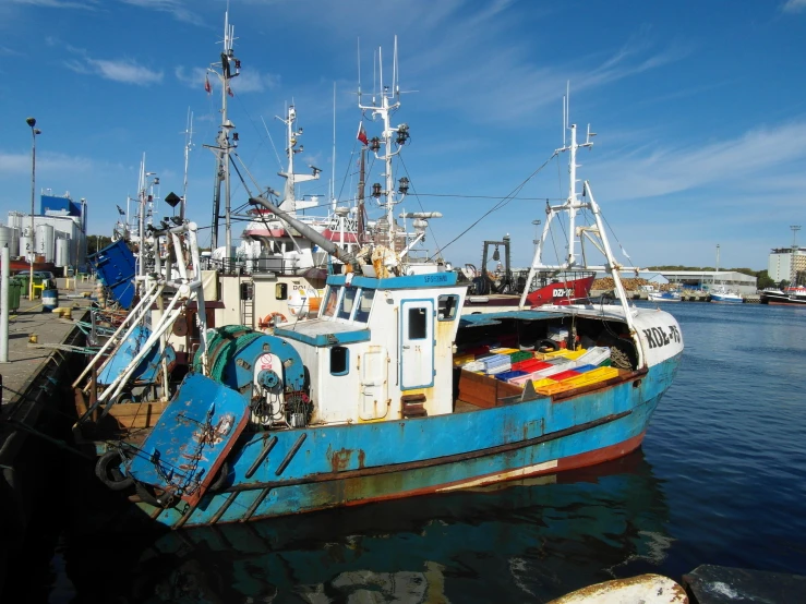 there is a small blue and white boat docked in the water