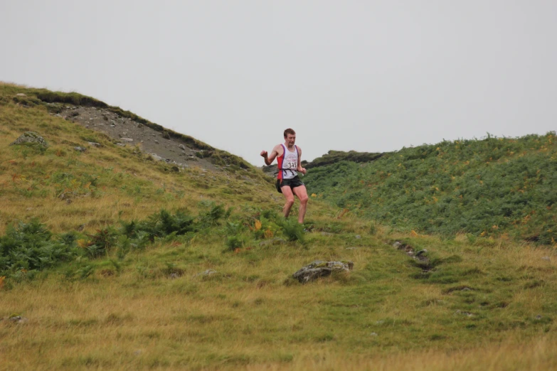 a man that is running in the grass