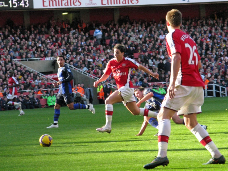 soccer players playing soccer during a stadium match