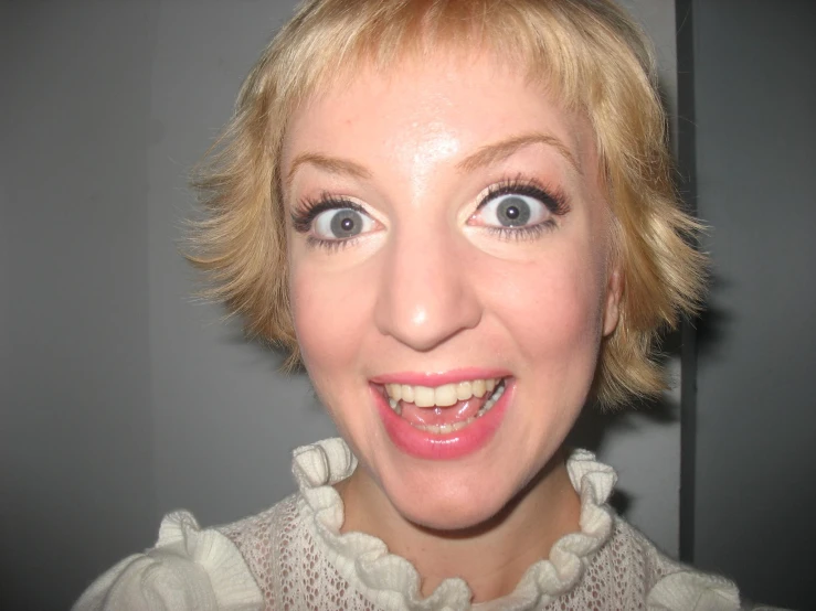 a close up of a woman smiling with her mouth open