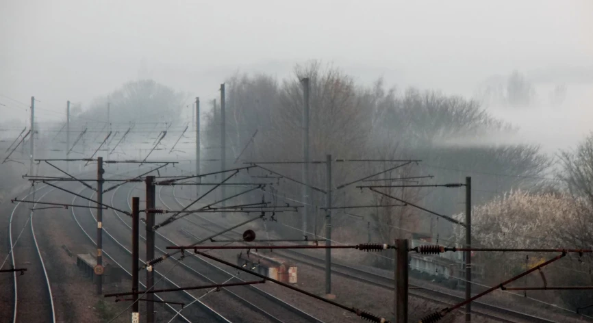 a view of a railroad track in the midst of the day