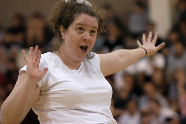 the woman is taking a stance as she tries to serve the ball