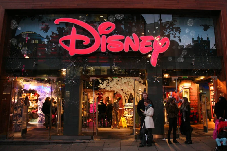 an outside view of a disney store at night
