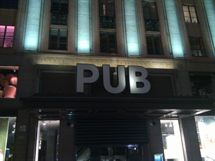 a building has a sign that says pub above it