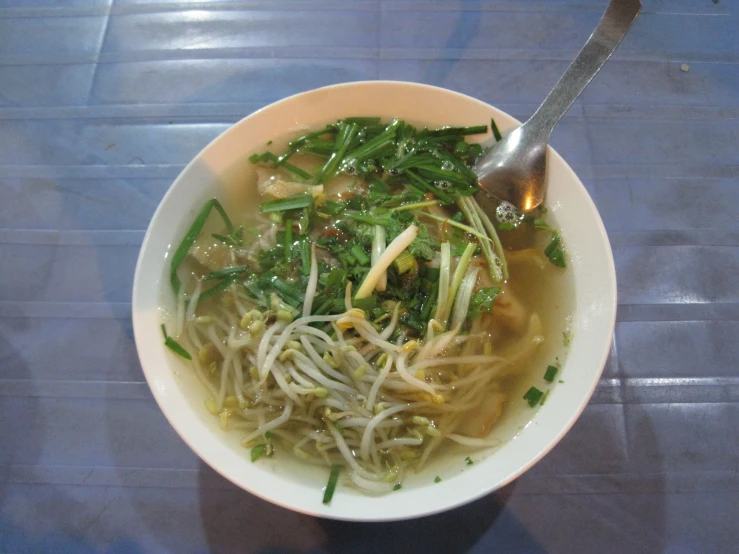 there is a small bowl filled with noodles and vegetables