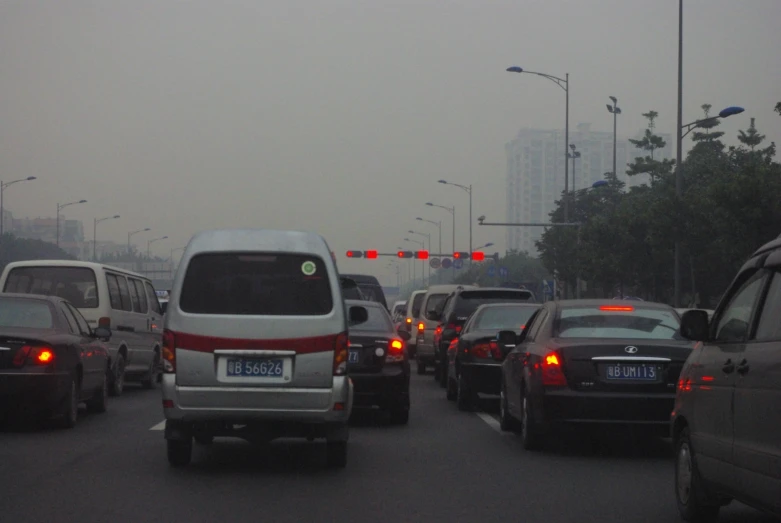 traffic at a red light in a heavy fog