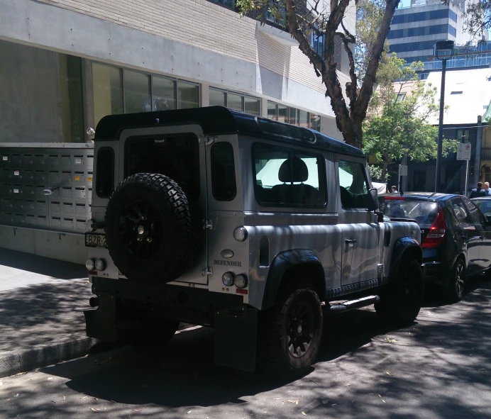 an suv with a huge tire on the front parked