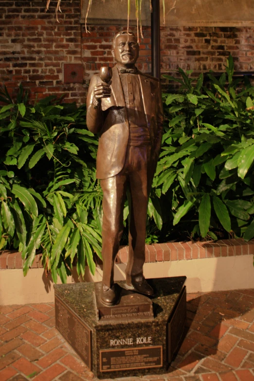 a statue of a man holding a glass