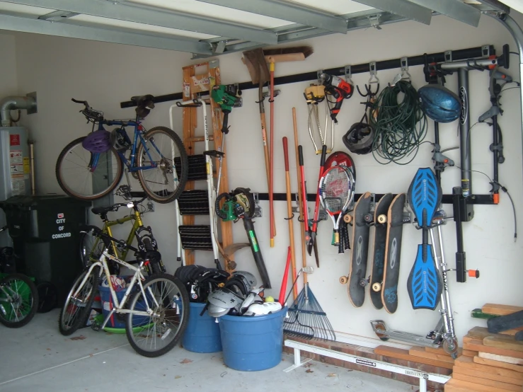 a garage with bicycles and kayaks hanging on the wall