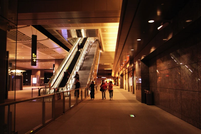 a group of people walking down an escalator