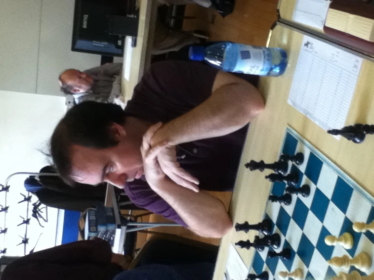 the man is playing a game of chess