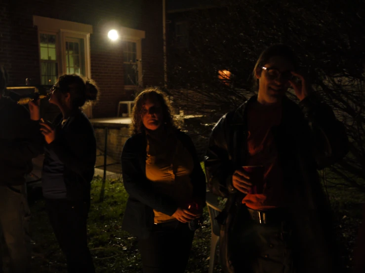 several people on the phone outside at night