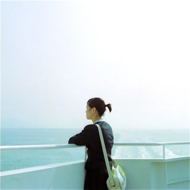 a woman standing on a ship looking out at the ocean