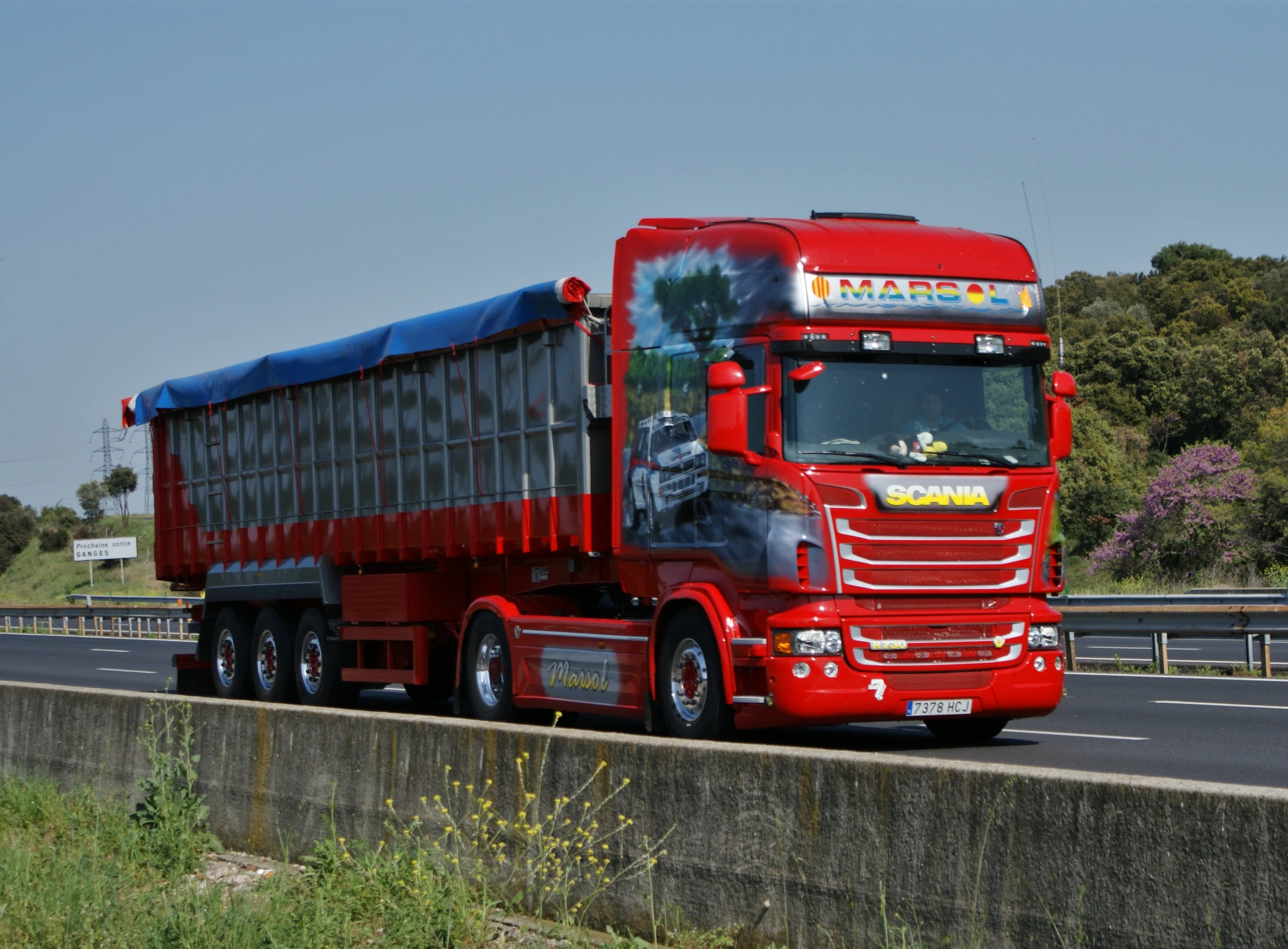 a big red truck with a trailer and back half is stopped