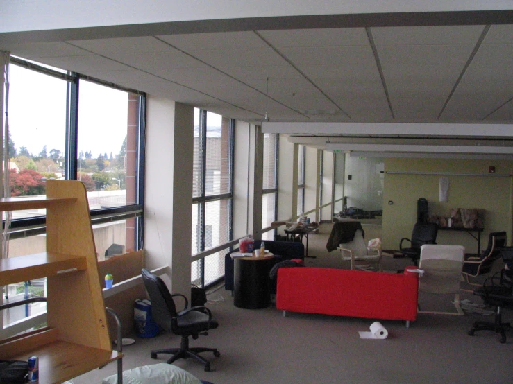 an office with chairs, couches and desks