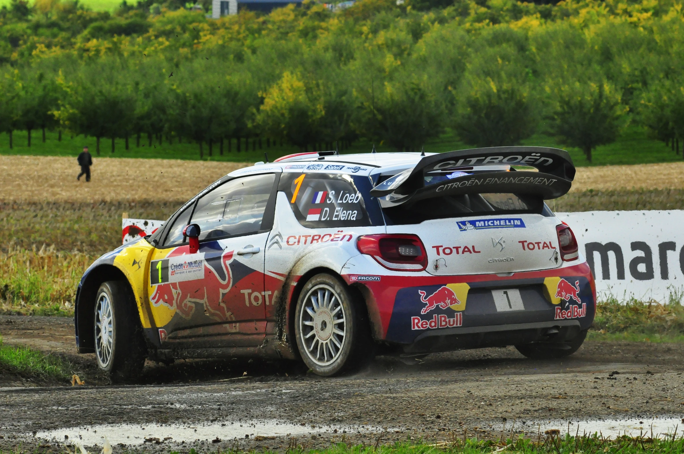 an athlete drives his car around the course