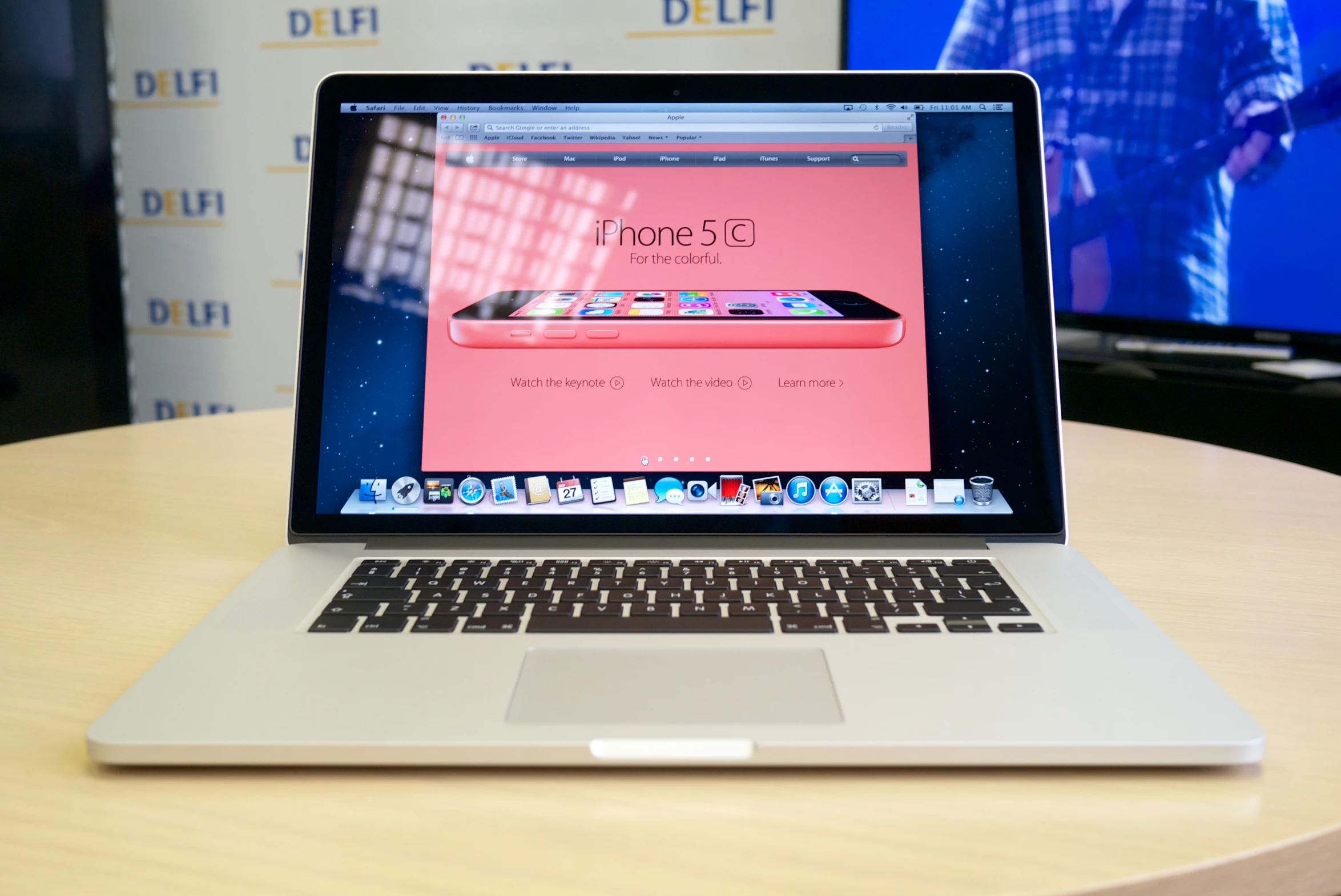 an apple macbook pro with an iphone showing the keyboard