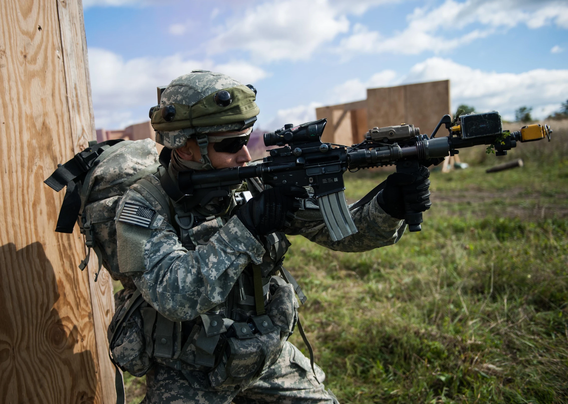 a soldier holding onto the side of a wooden plank