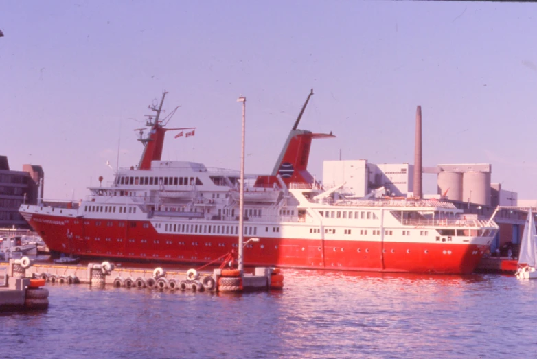 a large red and white boat docked at a dock