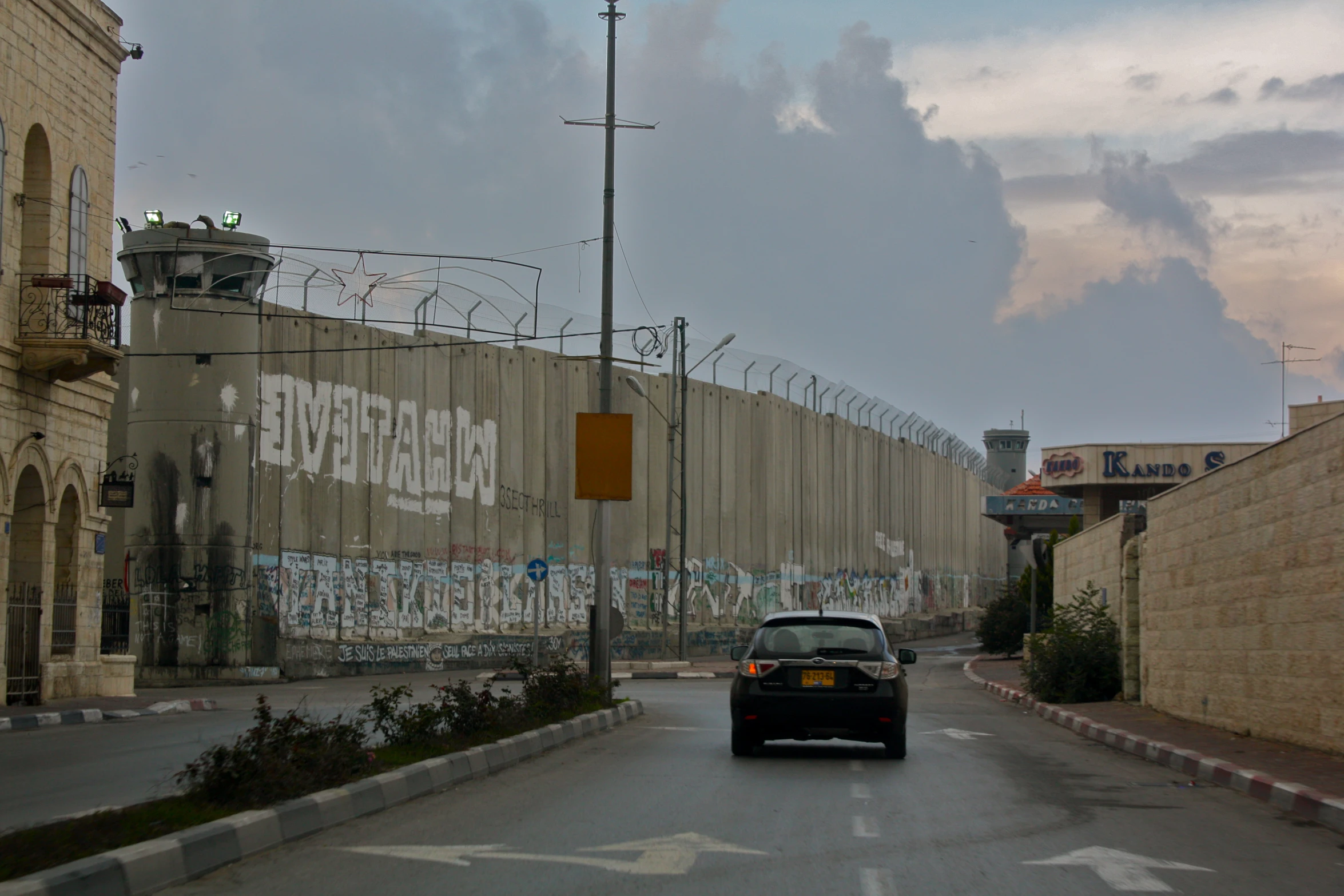 a view from the street looking towards a prison wall