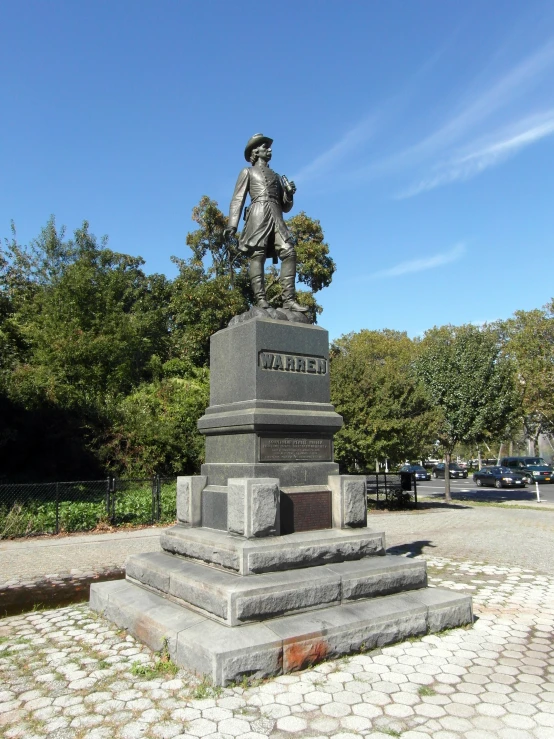 a monument with a statue of a man standing on top