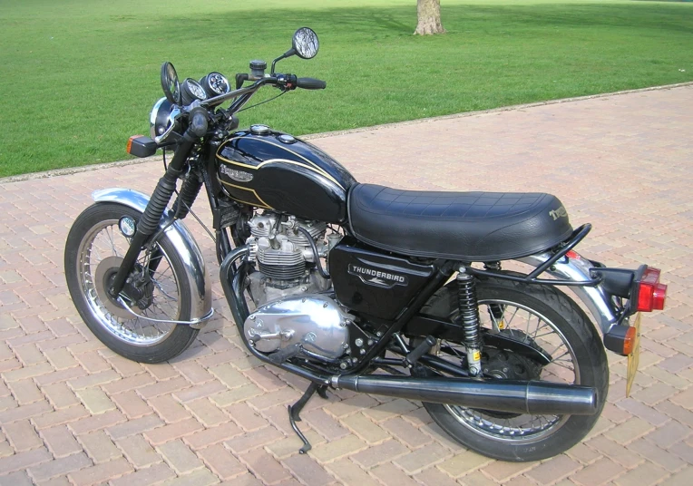a very nice looking motorcycle parked near some grass