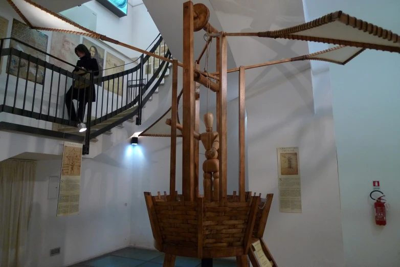 a sculpture made out of wood and rope in a room