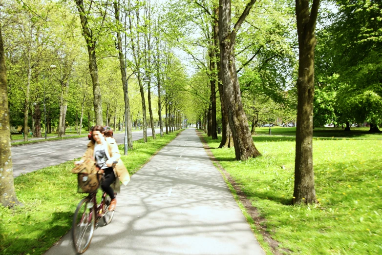 two people are riding on their bikes in a park